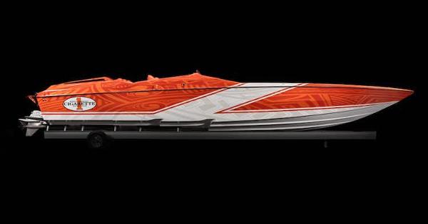 Slide: The Image of 2025 Cigarette 42' X speedboat with vibrant orange and white design on a trailer. - 6
