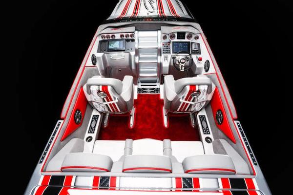 Slide: The Image of 2025 Cigarette 42' X boat interior with red and white seating and advanced dashboard. - 7