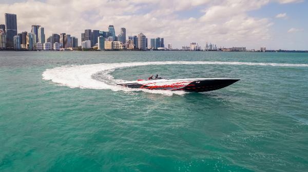 Slide: The Image of Cigarette 515 speedboat cruising near city skyline, 2022 model. - 1