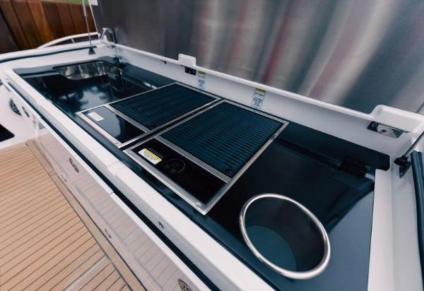 Slide: The Image of Outdoor kitchen on the 2024 Cigarette 52 Thunder boat with grill and sink. - 11