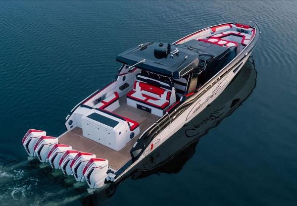 Slide: The Image of 2024 Cigarette 52 Thunder boat with multiple outboard engines on calm water. - 2