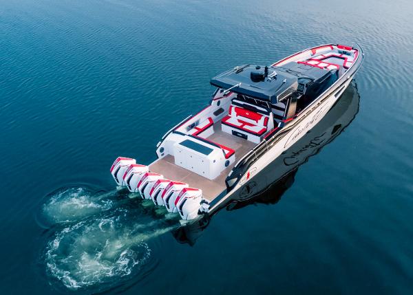 Slide: The Image of 2025 Cigarette 52 Thunder boat with five outboard engines on calm water. - 4