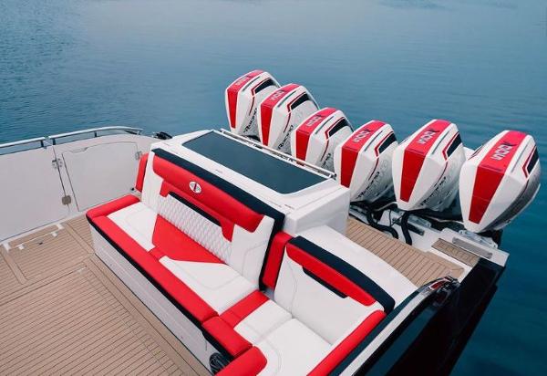 Slide: The Image of 2024 Cigarette 52 Thunder boat with red and white seating and six powerful outboard engines. - 5