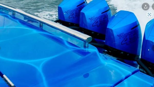Slide: The Image of 2024 Cigarette 59 Tirranna boat with blue exterior and powerful outboard engines. - 1
