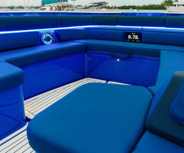 Slide: The Image of 2024 Cigarette 59 Tirranna boat interior with blue LED lighting and cushioned seating. - 11