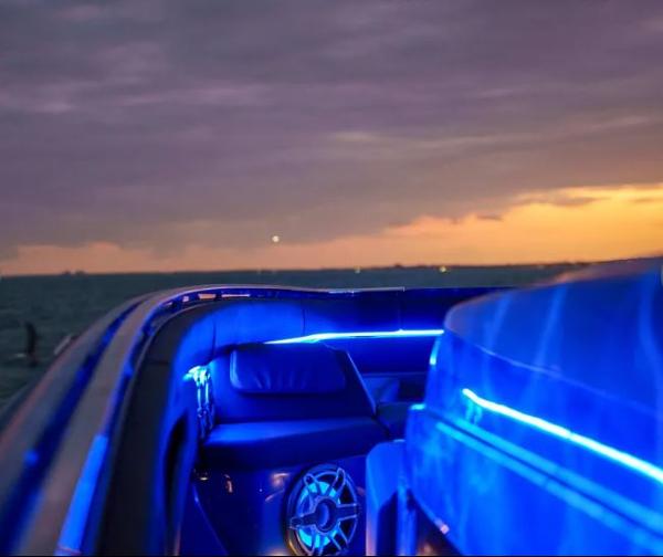 Slide: The Image of 2024 Cigarette 59 Tirranna boat interior with blue LED lighting at sunset. - 4