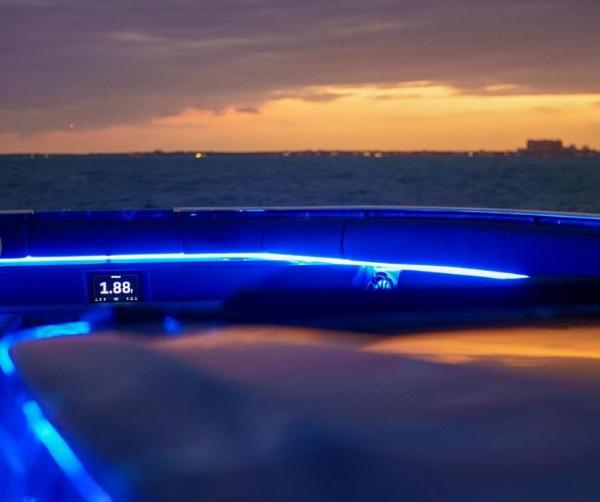 Slide: The Image of 2024 Cigarette 59 Tirranna boat with blue LED lights at sunset. - 5