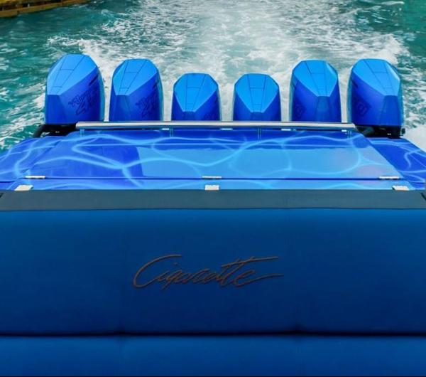 Slide: The Image of 2024 Cigarette 59 Tirranna boat with six blue outboard engines on water. - 8