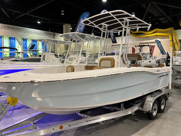 Slide: The Image of Clearwater 2000 2024 model boat on display in an indoor showroom. - 1