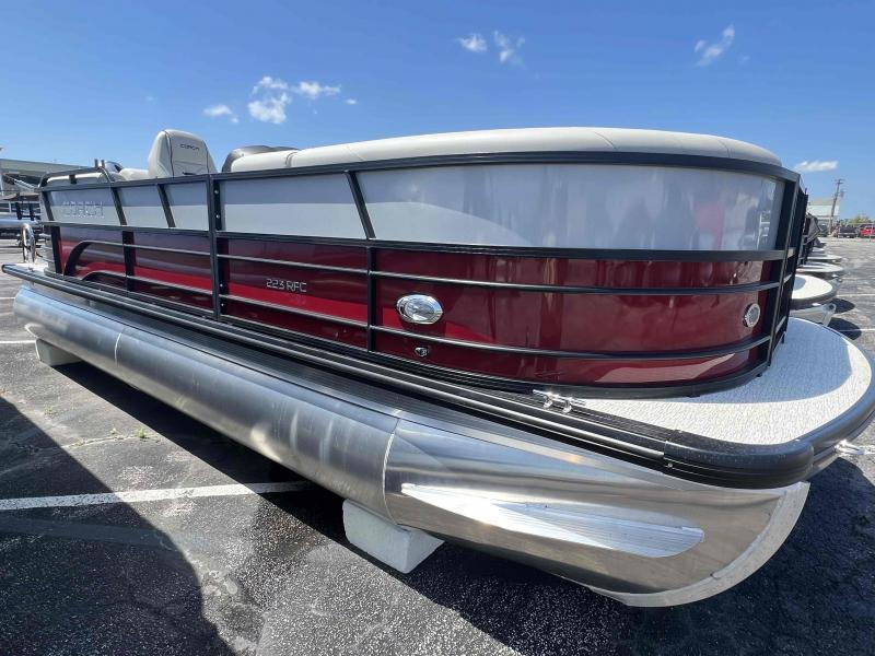 Slide: The Image of 2023 Coach 223 RFC pontoon boat with red and silver exterior. - 2
