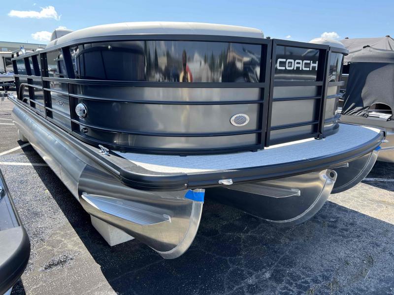 Slide: The Image of 2023 Coach 223 RFC pontoon boat in a parking lot. - 2