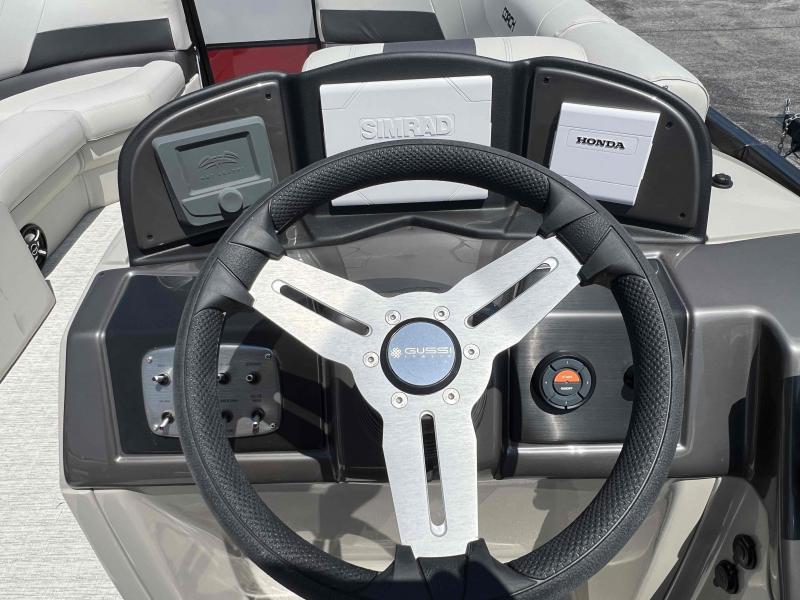 Slide: The Image of Steering wheel and dashboard of 2023 Coach 223 RFC boat with Simrad and Honda controls. - 7
