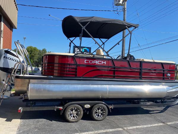 Slide: The Image of 2023 Coach Pontoons 223RFC pontoon boat with Honda engine on trailer. - 1