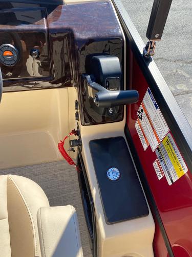 Slide: The Image of 2023 Coach Pontoons 223RFC control panel with throttle and safety features. - 10