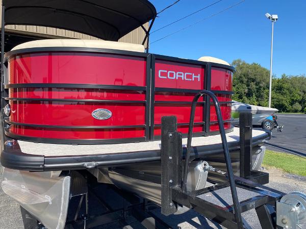 Slide: The Image of 2023 Coach Pontoons 223RFC, red pontoon boat on trailer, outdoor display. - 3