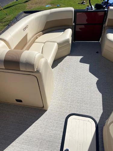 Slide: The Image of 2023 Coach Pontoons 223RFC interior with beige seating and carpet flooring. - 7