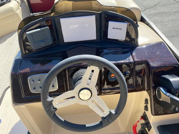 Slide: The Image of 2023 Coach Pontoons 223RFC dashboard with steering wheel and control panel. - 8
