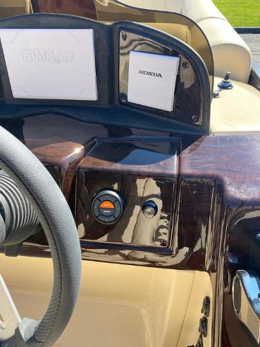 Slide: The Image of 2023 Coach Pontoons 223RFC dashboard with Honda controls and Simrad display. - 9