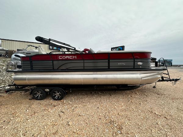 Slide: The Image of 2023 Coach Pontoons 243PFC pontoon boat on a trailer. - 1