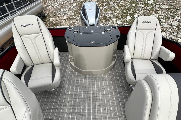 Slide: The Image of 2023 Coach Pontoons 243PFC interior with four luxurious seats and a central console. - 6