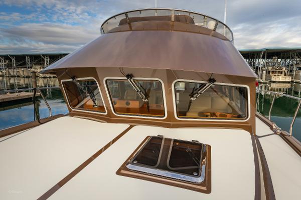 Slide: The Image of 2012 Coastal Craft 56 yacht with sleek design, docked at marina. - 10