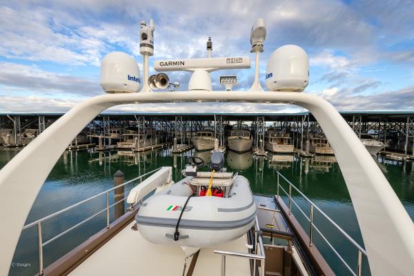 Slide: The Image of Coastal Craft 56 yacht, 2012 model, docked with inflatable boat on deck, marina background. - 11