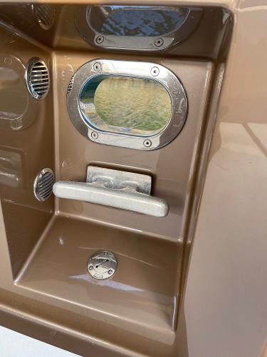 Slide: The Image of 2012 Coastal Craft 56 boat detail with metallic fixtures and porthole. - 19