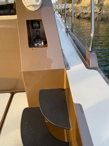 Slide: The Image of 2012 Coastal Craft 56 yacht with sleek steps and control panel by the water. - 20