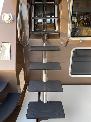 Slide: The Image of Staircase on 2012 Coastal Craft 56 yacht, featuring sleek metal and black steps. - 21