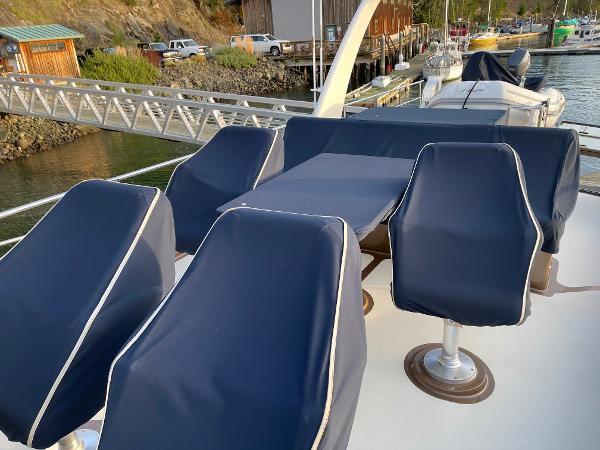Slide: The Image of Covered seating area on a 2012 Coastal Craft 56 yacht docked at a marina. - 23