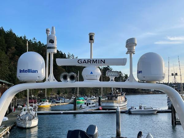 Slide: The Image of Coastal Craft 56 yacht with Garmin and Intellian equipment, docked in a scenic marina, 2012 model. - 25