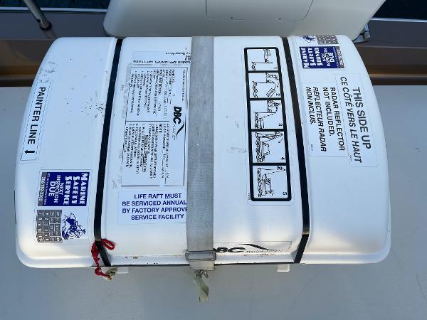 Slide: The Image of Life raft container on a 2012 Coastal Craft 56 yacht deck, labeled with safety instructions. - 27