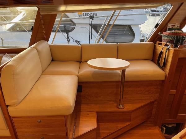 Slide: The Image of Luxurious interior of 2012 Coastal Craft 56 yacht with beige seating and wooden accents. - 32