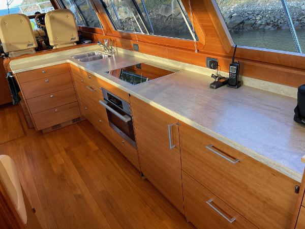 Slide: The Image of Luxurious kitchen interior of 2012 Coastal Craft 56 yacht with wooden cabinetry and modern appliances. - 33