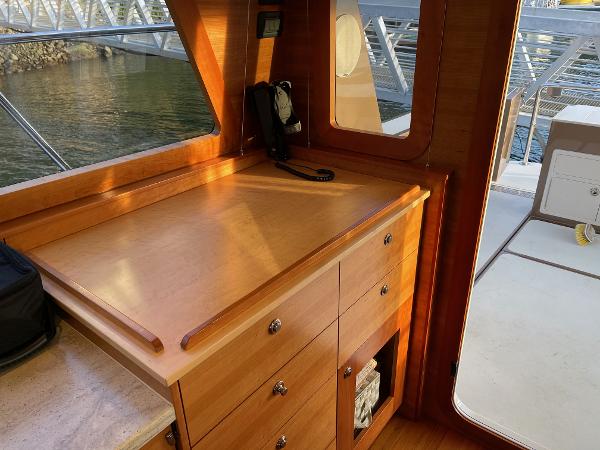 Slide: The Image of Interior of 2012 Coastal Craft 56 yacht with wooden cabinetry and window view. - 34