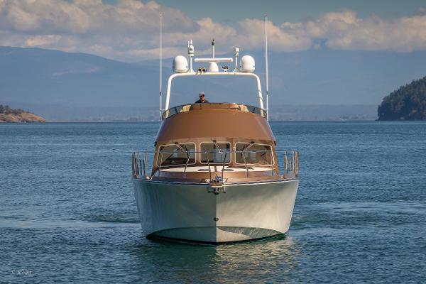Slide: The Image of Luxury 2012 Coastal Craft 56 yacht cruising on serene blue waters. - 4