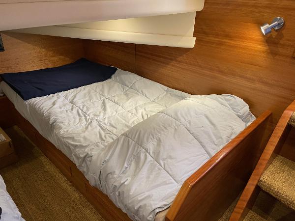 Slide: The Image of Cozy cabin bed in 2012 Coastal Craft 56 yacht, featuring wooden interior and soft lighting. - 41