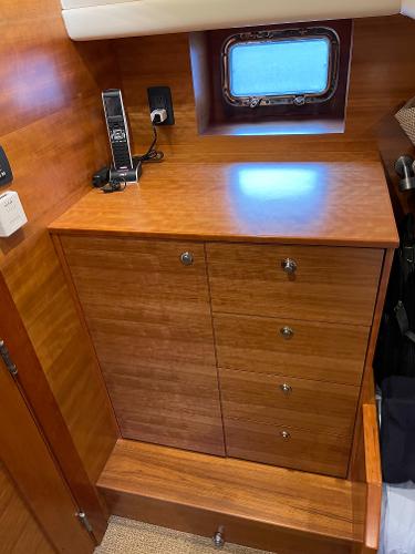 Slide: The Image of Wooden cabinetry inside a 2012 Coastal Craft 56 yacht, featuring drawers and a small window. - 45
