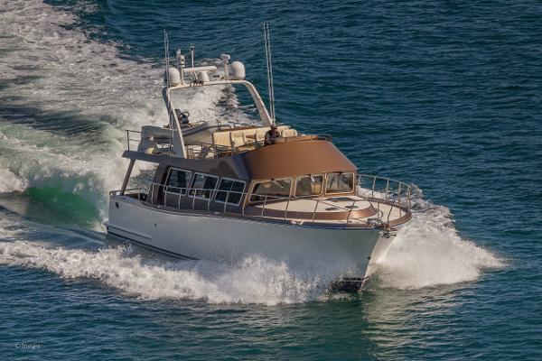 Slide: The Image of 2012 Coastal Craft 56 yacht cruising on open water. - 5