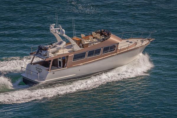 Slide: The Image of 2012 Coastal Craft 56 yacht cruising on open water, showcasing sleek design and luxury features. - 7