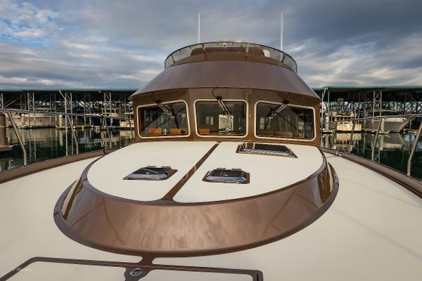 Slide: The Image of 2012 Coastal Craft 56 yacht docked at marina under cloudy sky. - 9