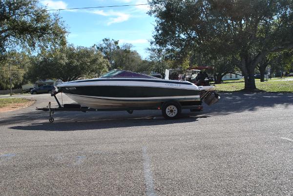 Slide: The Image of 1998 Cobalt 200 boat on trailer in sunny outdoor setting. - 16