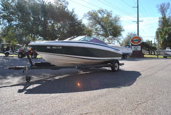 Slide: The Image of 1998 Cobalt 200 boat on trailer in sunny outdoor setting. - 17