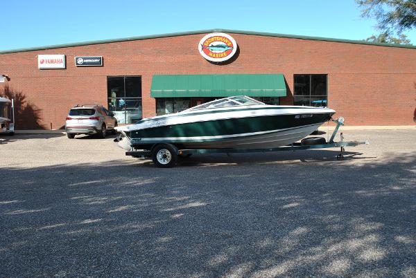 Slide: The Image of 1998 Cobalt 200 boat on trailer in front of a brick building. - 21