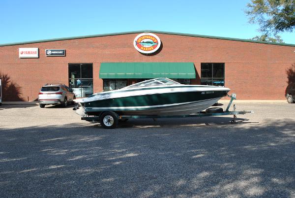 Slide: The Image of 1998 Cobalt 200 boat on trailer outside a brick building with green awning. - 22