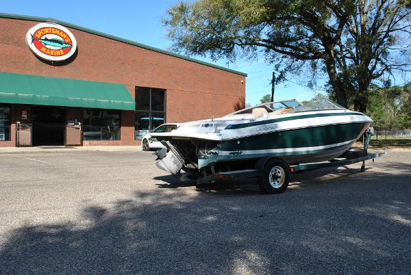 Slide: The Image of 1998 Cobalt 200 boat on trailer outside dealership, sunny day. - 23