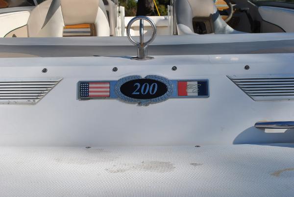 Slide: The Image of 1998 Cobalt 200 boat with American and French flags on the rear. - 25