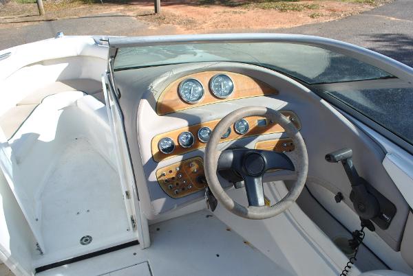 Slide: The Image of 1998 Cobalt 200 boat dashboard with steering wheel and instrument panel. - 28