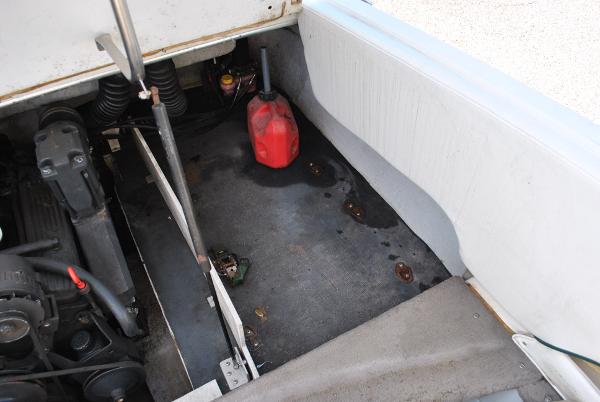 Slide: The Image of 1998 Cobalt 200 boat engine compartment with red fuel container and visible engine parts. - 35