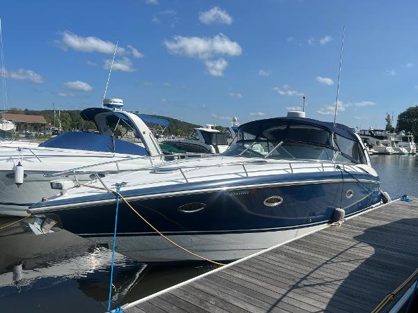 Slide: The Image of 2003 Cobalt 360 boat docked at a marina on a sunny day. - 1